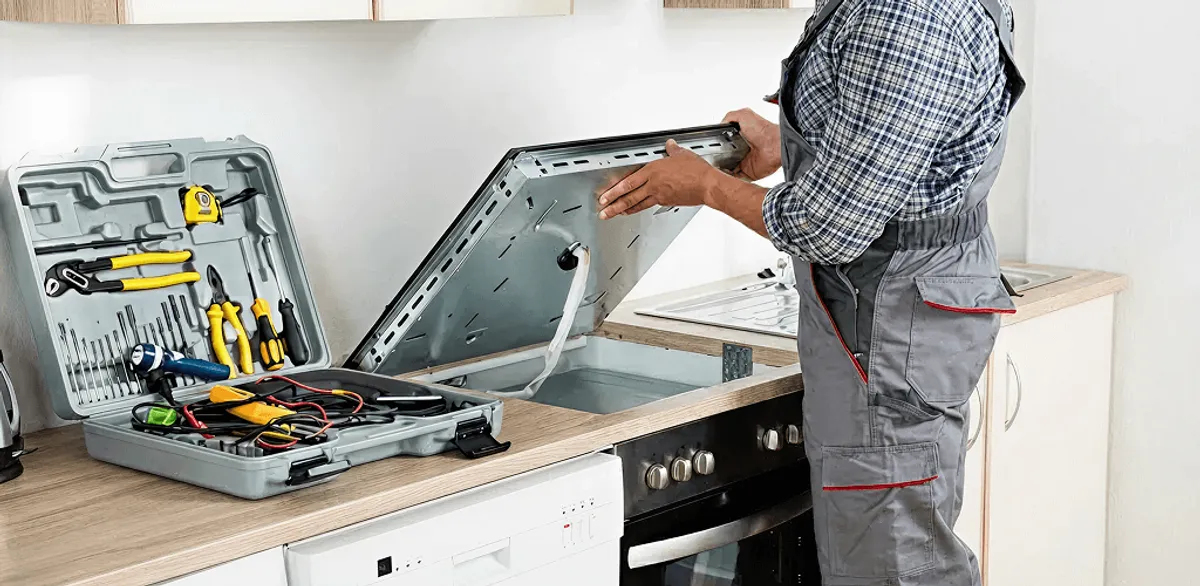 Handyman repairing a cooktop and checking wiring connections in Tacoma, WA