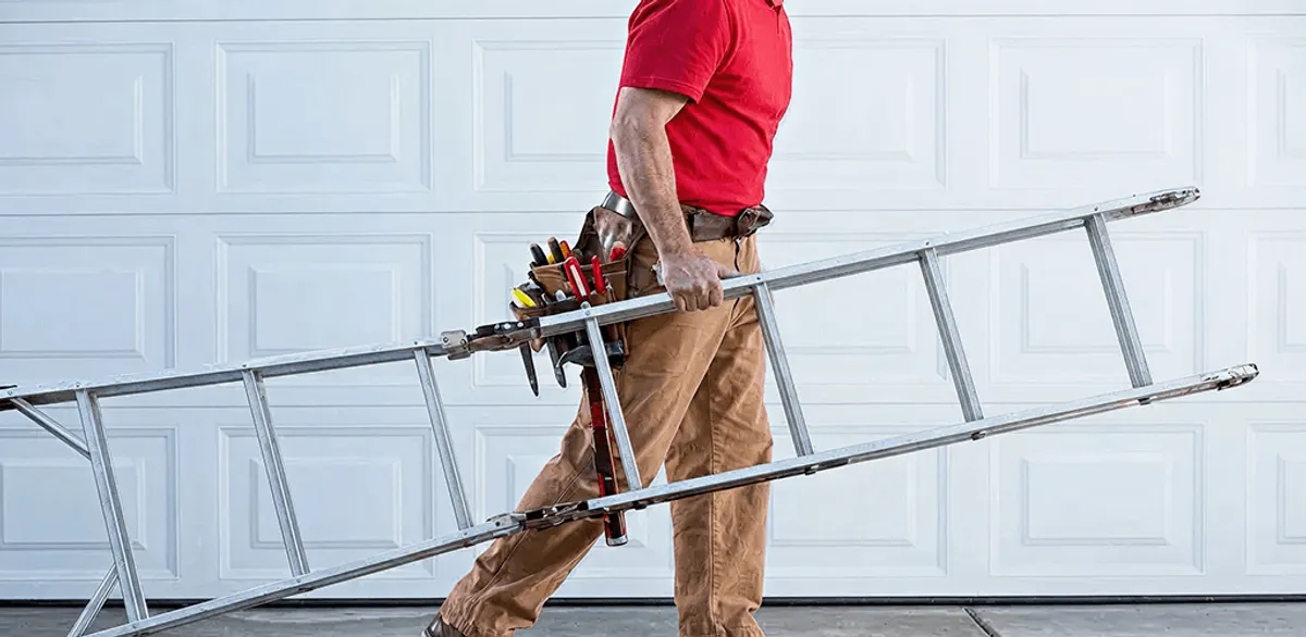 Garage door repair technician arriving with tools and ladder in Tacoma, WA