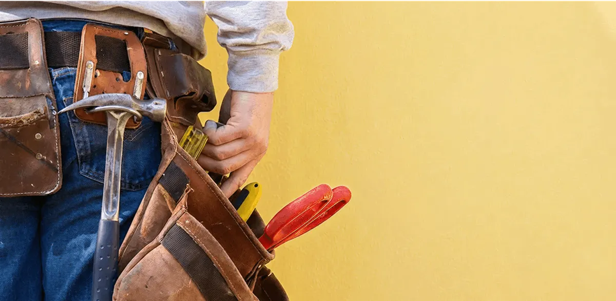 Handyman with tool belt ready for home repairs and maintenance in Tacoma, WA
